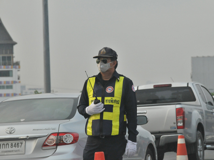 ▲バンコクで交通関係を担当する警察官はサングラスとマスクが必需。高速道路でも生身で立って、交通整理や監視を行っている